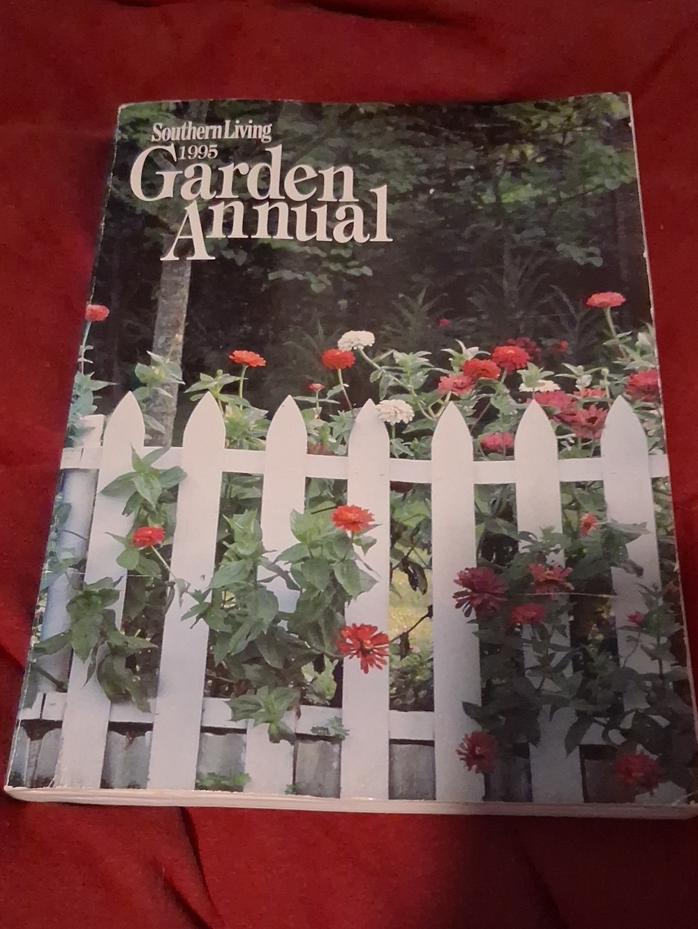 Southern Living Garden Annual with White Picket Fence and Red Flowers